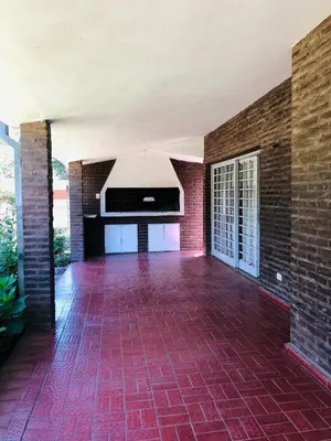 an empty living room with a brick wall at Casa frente al rio San Antonio Playas de Oro Villa Carlos Paz in Villa Carlos Paz