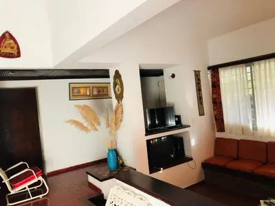 a living room with a couch and a tv at Casa frente al rio San Antonio Playas de Oro Villa Carlos Paz in Villa Carlos Paz