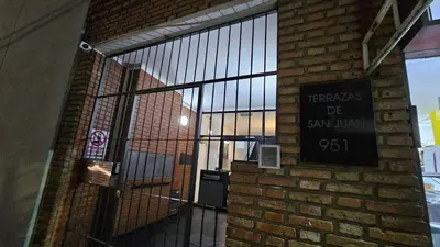 an entrance to a brick building with a sign on the door at Terrazas de San Juan in Cordoba