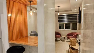 a lobby with chairs and a table and a window at Terrazas de San Juan in Cordoba