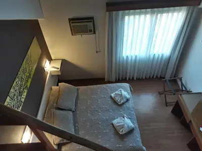 a living room with a couch and a window at Costanera Hotel in Villa Carlos Paz