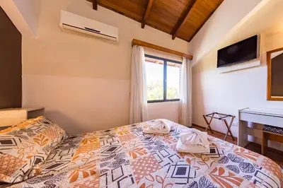 a bedroom with a bed and a window at Costanera Hotel in Villa Carlos Paz