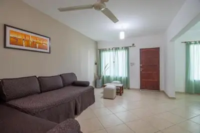a living room with a couch and a ceiling fan at Soles del lago in Villa Carlos Paz