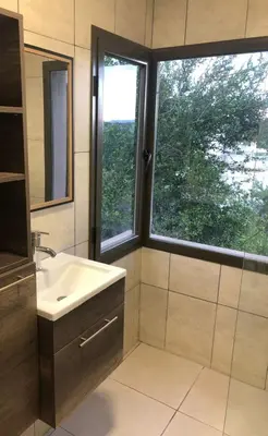 a bathroom with a sink and a window at Terra Bella PA in Villa Carlos Paz