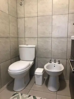 a bathroom with a toilet and a sink at Terra Bella PA in Villa Carlos Paz