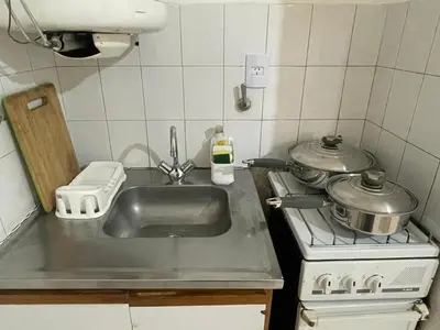 a kitchen with a sink and a stove at Departamento en Nueva Córdoba in Cordoba