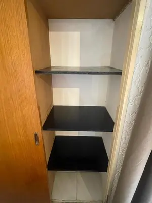 a empty closet with black shelves in a room at Departamento en Nueva Córdoba in Cordoba