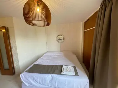 a small bed in a room with a light at Departamento en Nueva Córdoba in Cordoba