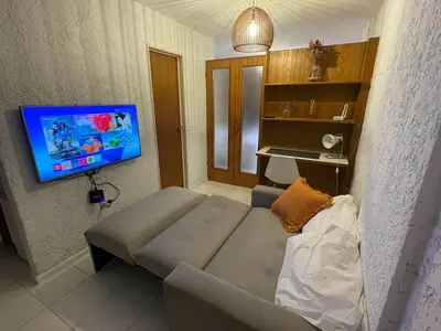 a living room with a couch and a flat screen tv at Departamento en Nueva Córdoba in Cordoba
