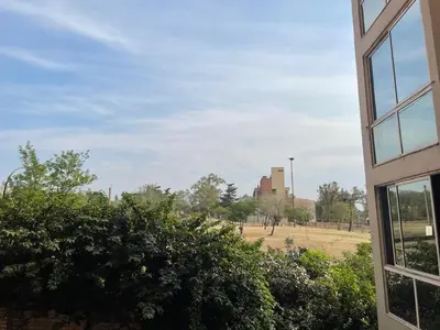 a view of a field from the window of a building at Departamento en Nueva Córdoba in Cordoba