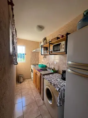 a kitchen with a washing machine and a refrigerator at Cabañas aires de montaña in Villa Parque Siquiman