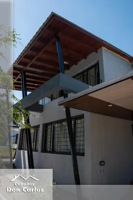 a building with awning in front of it at Cabañas Don Carlos in Villa Carlos Paz