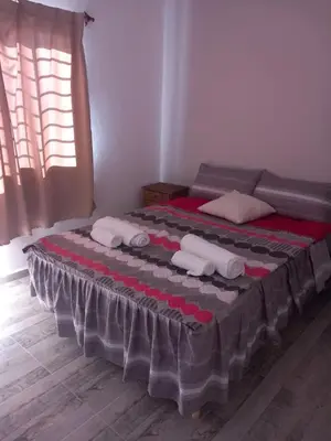 a bedroom with a bed with towels on it at 2 Dormitorios y pileta in Villa Anizacate