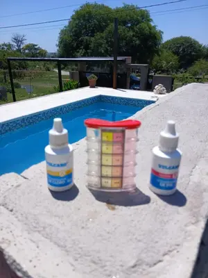 three plastic containers sitting next to a swimming pool at 2 Dormitorios y pileta in Villa Anizacate