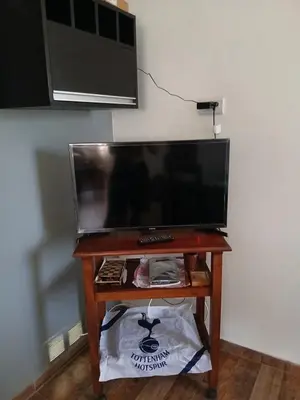 a small table with a television on top of it at 2 Dormitorios y pileta in Villa Anizacate