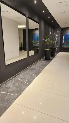 an empty lobby with potted plants and mirrors at Sarmiento deluxe B General Paz Pax 4 in Cordoba