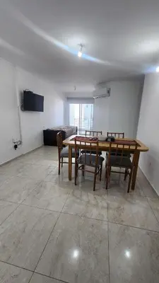 a dining room with a wooden table and chairs at Sarmiento deluxe B General Paz Pax 4 in Cordoba