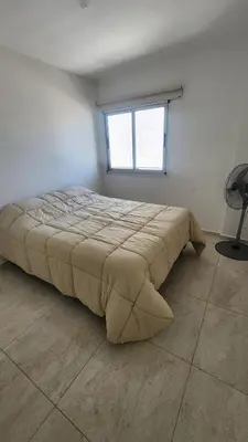 a large bed in a room with a window at Sarmiento deluxe B General Paz Pax 4 in Cordoba