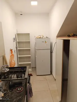 a kitchen with a white refrigerator and a stove at Yatel in Santa Rosa de Calamuchita
