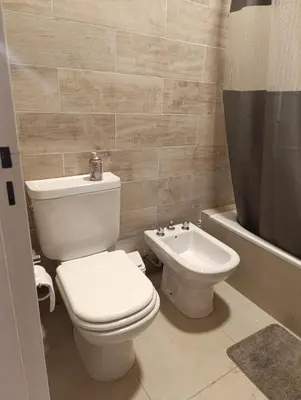 a bathroom with a toilet and a bidet at Yatel in Santa Rosa de Calamuchita