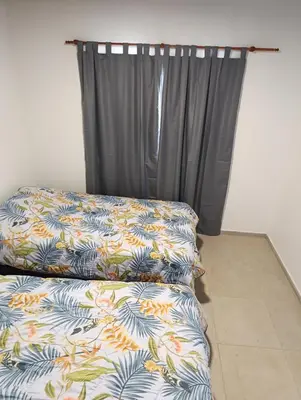 a bedroom with a couch and a curtain at Yatel in Santa Rosa de Calamuchita