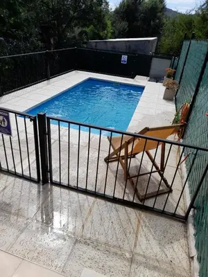 a swimming pool with a chair next to a fence at Casa Sol Serrano - con todas las comodidades y excelente ubicación in Villa Carlos Paz