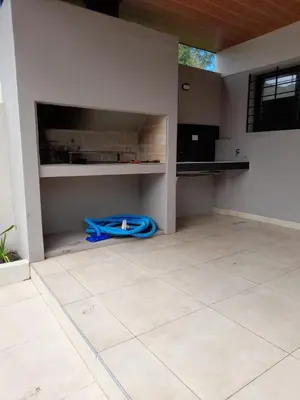 a kitchen with a blue hose laying on the floor at Casa Sol Serrano - con todas las comodidades y excelente ubicación in Villa Carlos Paz