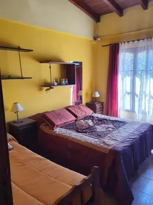 a bedroom with two beds in a room at Paseo por las Nubes in Santa Rosa de Calamuchita