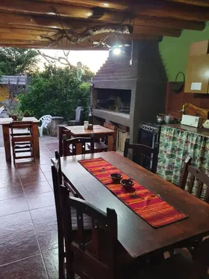 a kitchen with a wooden table and a stove at Paseo por las Nubes in Santa Rosa de Calamuchita