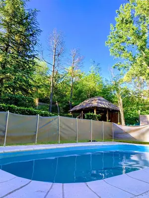 a swimming pool with a fence and a gazebo at Cabañas Cuñas del Trapiche in Trapiche