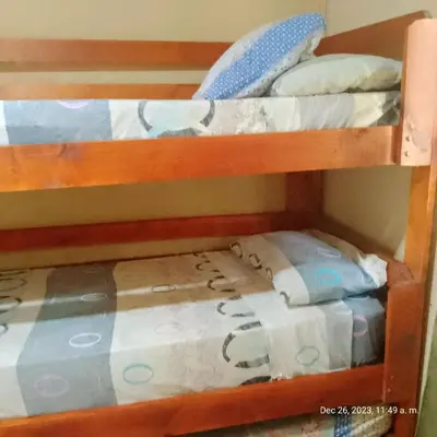 two bunk beds in a room with a bed at Cabaña del mallin in Bialet Massé