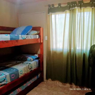 a bedroom with two bunk beds and a window at Cabaña del mallin in Bialet Massé