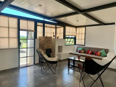 a living room with a couch and chairs and a table at La Casona de Tanti in Tanti