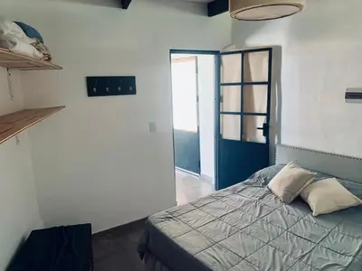 a bedroom with a bed in a room with a window at La Casona de Tanti in Tanti