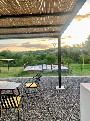 a patio with a table and two chairs and a picnic table at La Casona de Tanti in Tanti