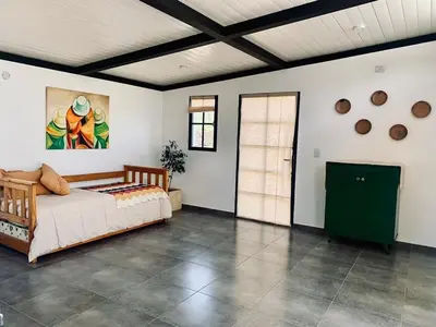 a bedroom with a bed and a green cabinet at La Casona de Tanti in Tanti