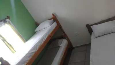 two bunk beds in a room with a window at Cabañas Mimi in Villa Anizacate