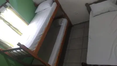 two bunk beds in a room with a window at Cabañas Mimi in Villa Anizacate