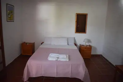 a bedroom with a bed with two towels on it at Residencial El Amancer in Mina Clavero