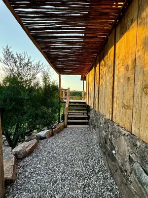a wooden building with a wooden roof and stairs at Cabañas vizcarra in Villa Carlos Paz
