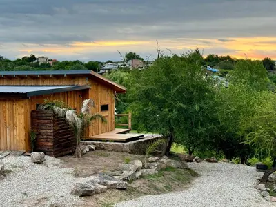 a wooden cabin with a porch and a deck at Cabañas vizcarra in Villa Carlos Paz