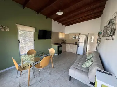 a living room with a couch and a table and chairs at 