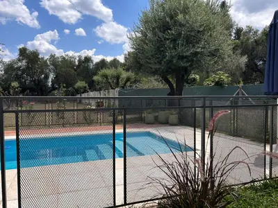 a fence with a swimming pool in a yard at 