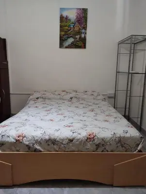 a bed in a room with a picture on the wall at Casa La Moradita in Villa Parque Siquiman