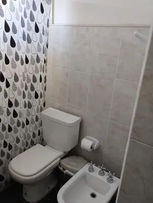 a bathroom with a toilet and a sink at Casa La Moradita in Villa Parque Siquiman