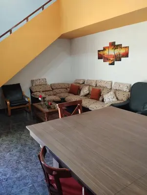 a living room with a table and a couch at Casa La Moradita in Villa Parque Siquiman