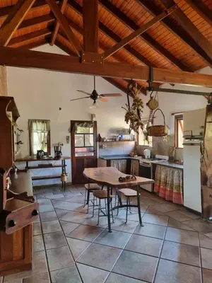 a kitchen with a wooden ceiling and a table at Las Veronas in Villa de Las Rosas