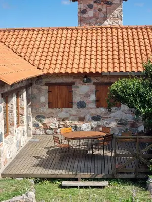 a table and chairs on a deck in front of a building at Las Veronas in Villa de Las Rosas