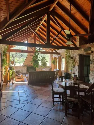 a living room with a table and a couch at Las Veronas in Villa de Las Rosas