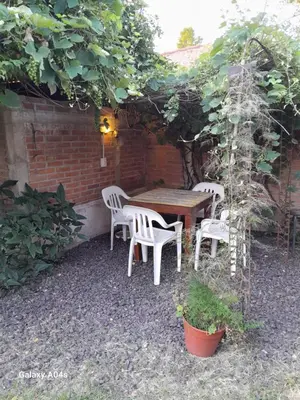 a wooden table and chairs under an arbor at Mifauna in Villa del Dique